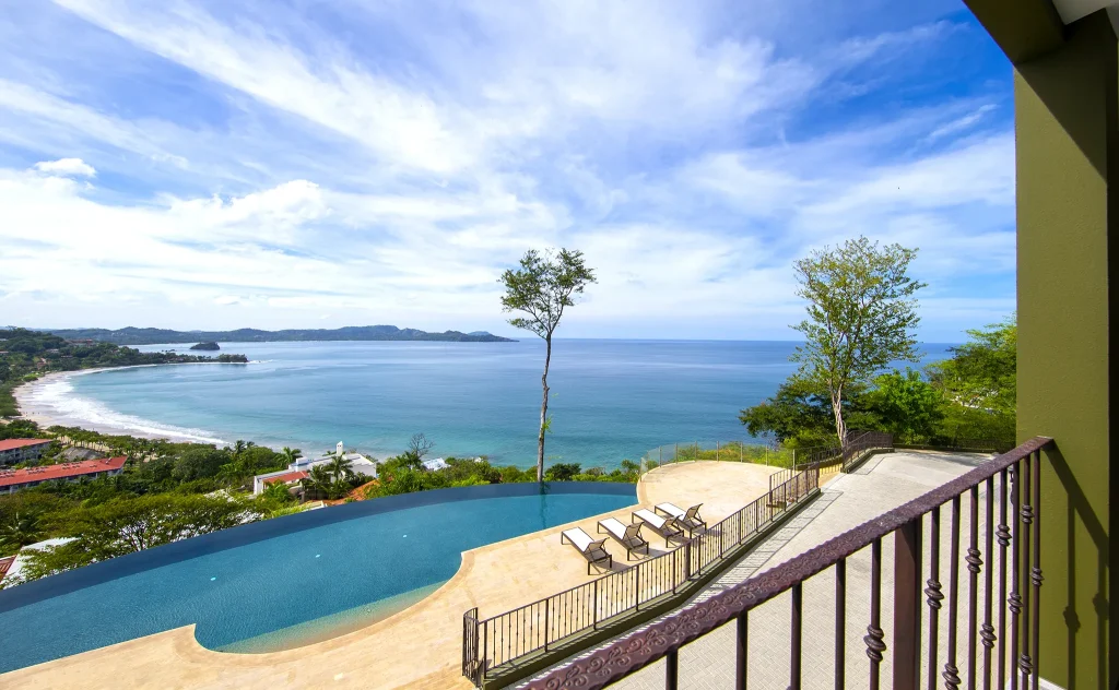The infinity pool and terrace at 360 Splendor overlooking the crescent bay of Playa Flamingo and the Pacific.