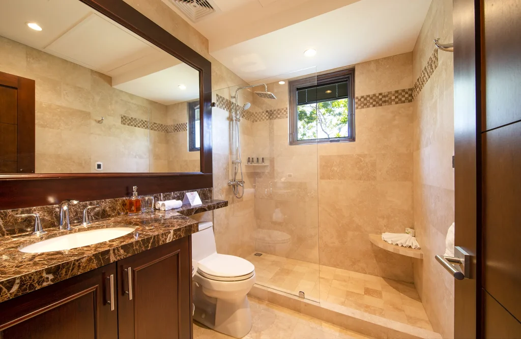 En-suite bathroom at 360 Splendor with a walk-in travertine shower.