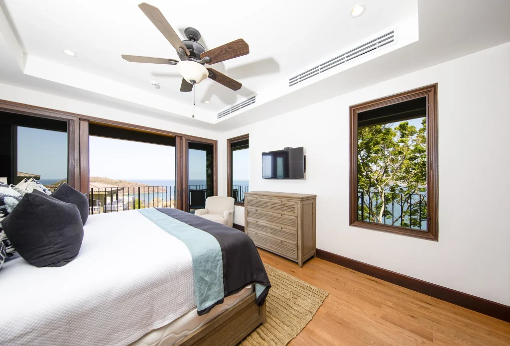 Bedroom at 360 Splendor with a private balcony overlooking the Pacific.