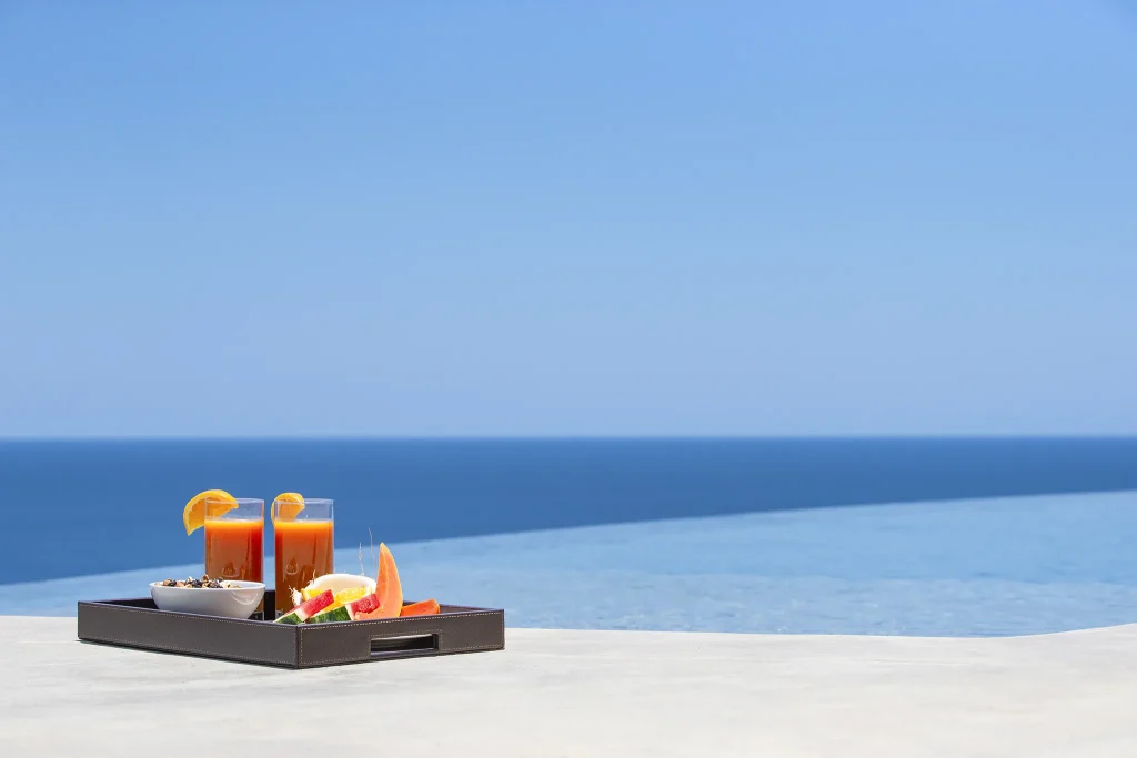 Fresh fruit and juice on the infinity-pool ledge at 360 Splendor, overlooking the Pacific.
